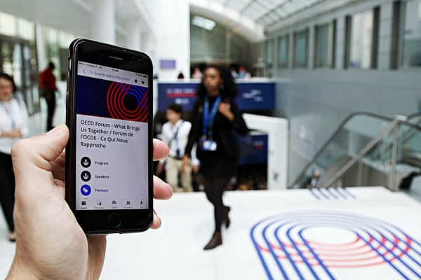 The OECD Forum used Swapcard's branded event app with a lot of blue (and some red) to engage delegates and attendees